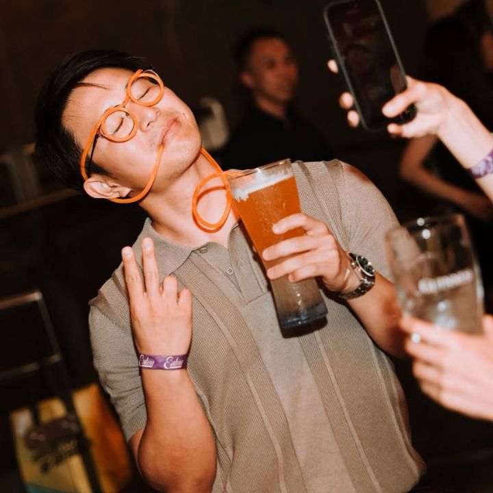 man drinking beer from a straw at Flower Years hong kong for its halloween party "Brew Haunt" in october 2025