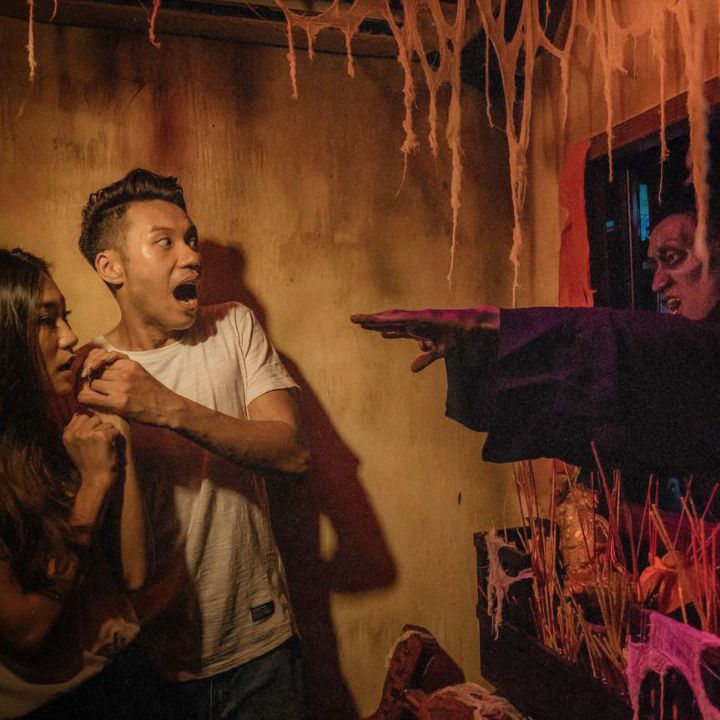 two people screaming in a haunted house at ocean park hong kong for its halloween party in october 2025