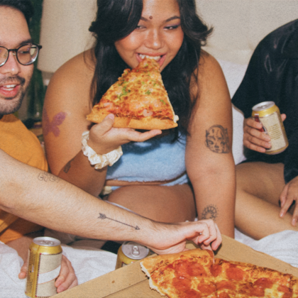 group of friends eating pizza late at night in hong kong