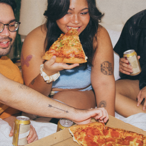 group of friends eating pizza late at night in hong kong